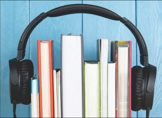 headphone and books on blue background. audiobook