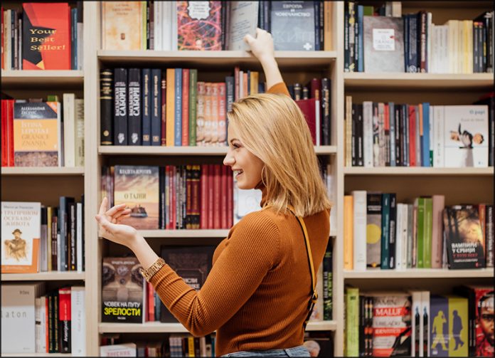 woman in front of bookshelves in a bookstore
